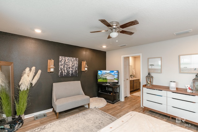 sitting room featuring light hardwood / wood-style flooring and ceiling fan