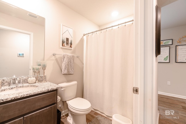 bathroom with vanity, toilet, curtained shower, and wood-type flooring