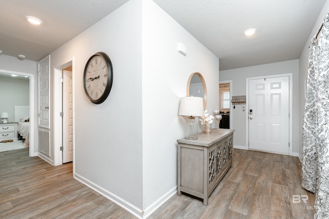 foyer with a textured ceiling and hardwood / wood-style flooring