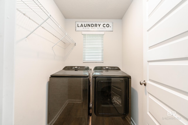 laundry area with hardwood / wood-style floors and washing machine and clothes dryer