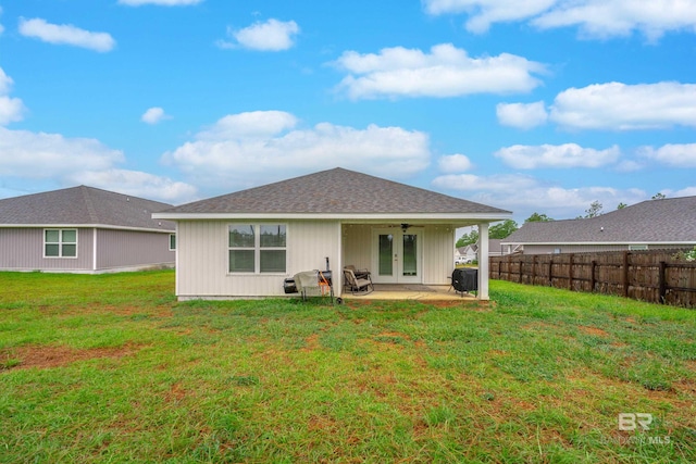 back of property with a patio area, ceiling fan, a yard, and french doors