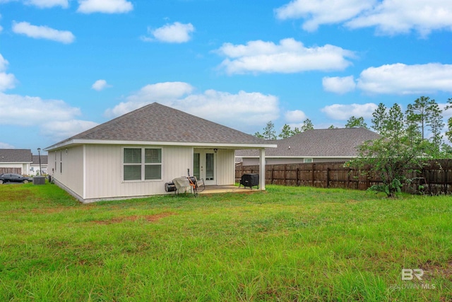 back of property featuring a yard and a patio area