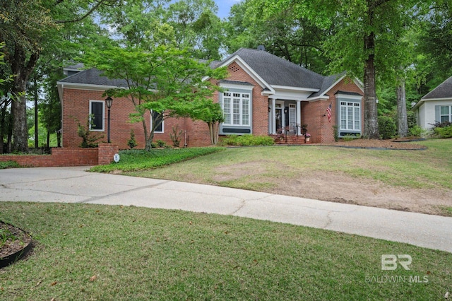 137 Mcintosh Bluff Rd, Fairhope, AL 36532 - view of front of property with brick siding, a front lawn, and a shingled roof
