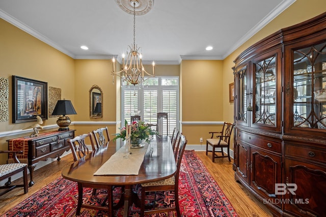 137 Mcintosh Bluff Rd, Fairhope, AL 36532 - dining space featuring a chandelier, light wood-style flooring, recessed lighting, crown molding, and baseboards