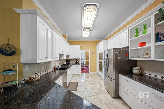 137 Mcintosh Bluff Rd, Fairhope, AL 36532 - kitchen with stainless steel appliances, dark stone counters, white cabinets, a sink, and tasteful backsplash