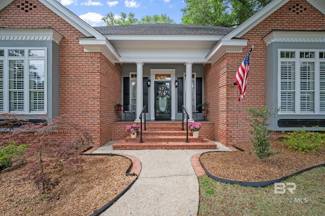 137 Mcintosh Bluff Rd, Fairhope, AL 36532 - property entrance featuring brick siding, covered porch, and a shingled roof