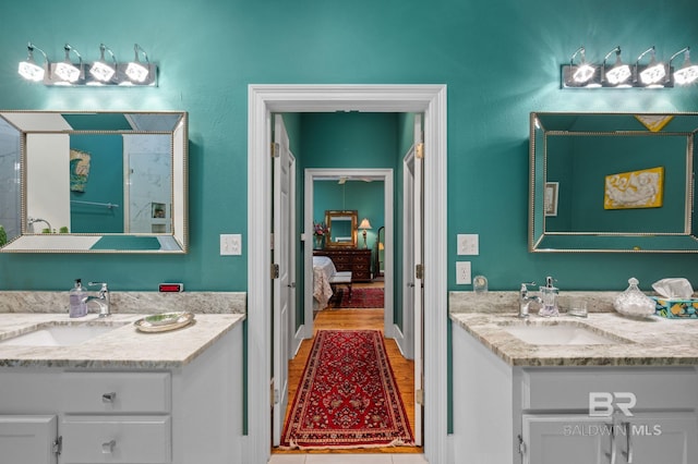 137 Mcintosh Bluff Rd, Fairhope, AL 36532 - bathroom featuring a shower stall, wood finished floors, and two vanities
