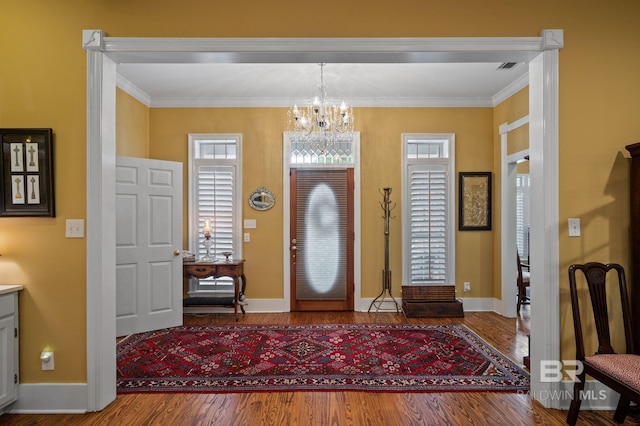 137 Mcintosh Bluff Rd, Fairhope, AL 36532 - entryway with a chandelier, baseboards, wood finished floors, and crown molding