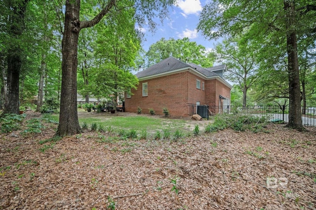 137 Mcintosh Bluff Rd, Fairhope, AL 36532 - view of home's exterior with fence, brick siding, and central AC