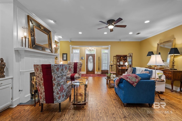 137 Mcintosh Bluff Rd, Fairhope, AL 36532 - living room featuring wood finished floors, a ceiling fan, crown molding, a fireplace, and recessed lighting
