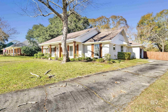 single story home featuring a front lawn and a garage