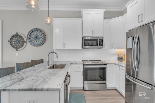 1592 W Beach Blvd, Gulf Shores, AL 36542 - kitchen featuring light stone countertops, hanging light fixtures, white cabinets, sink, and stainless steel appliances