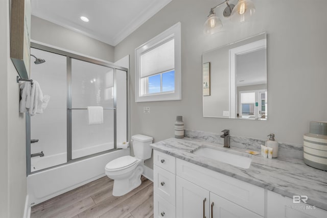 1592 W Beach Blvd, Gulf Shores, AL 36542 - full bathroom featuring toilet, crown molding, wood-type flooring, bath / shower combo with glass door, and vanity
