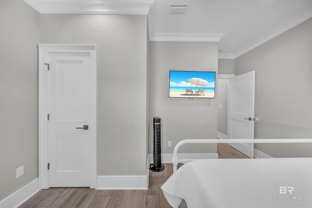 1592 W Beach Blvd, Gulf Shores, AL 36542 - bedroom with crown molding and light wood-type flooring
