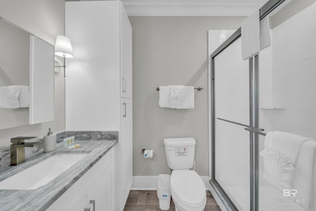1592 W Beach Blvd, Gulf Shores, AL 36542 - bathroom with vanity, toilet, ornamental molding, and a shower with door