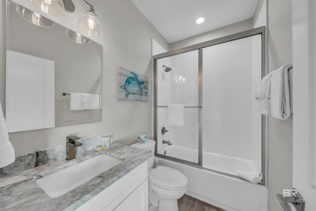 1592 W Beach Blvd, Gulf Shores, AL 36542 - full bathroom with wood-type flooring, bath / shower combo with glass door, toilet, and vanity