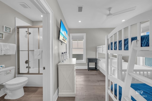 1592 W Beach Blvd, Gulf Shores, AL 36542 - interior space with toilet, bath / shower combo with glass door, ceiling fan, and wood-type flooring