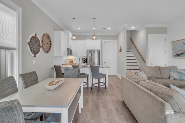 1592 W Beach Blvd, Gulf Shores, AL 36542 - dining area featuring crown molding and light wood-type flooring