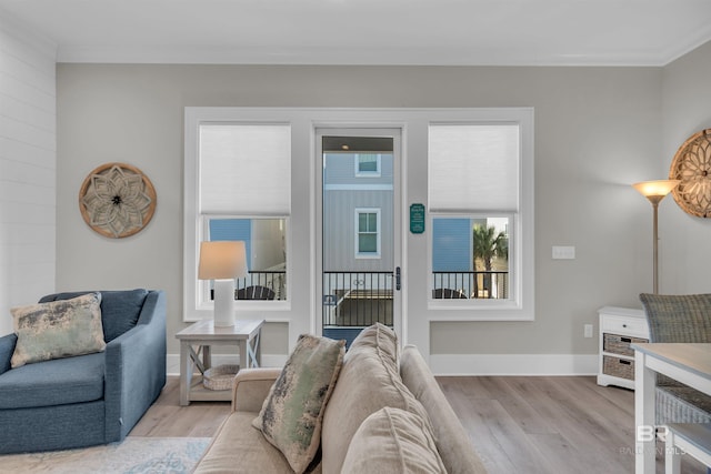 1592 W Beach Blvd, Gulf Shores, AL 36542 - living room with crown molding and light hardwood / wood-style floors