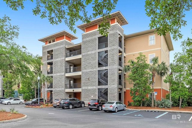 1430 Regency Rd Unit C201, Gulf Shores, AL 36542 - view of apartment building / complex featuring uncovered parking