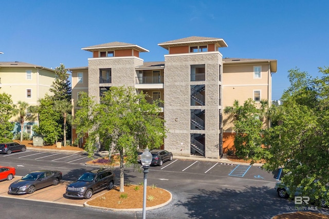 1430 Regency Rd Unit C201, Gulf Shores, AL 36542 - view of building exterior with uncovered parking