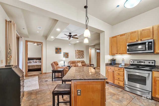 1430 Regency Rd Unit C201, Gulf Shores, AL 36542 - kitchen with appliances with stainless steel finishes, a ceiling fan, a kitchen breakfast bar, a center island, and open floor plan