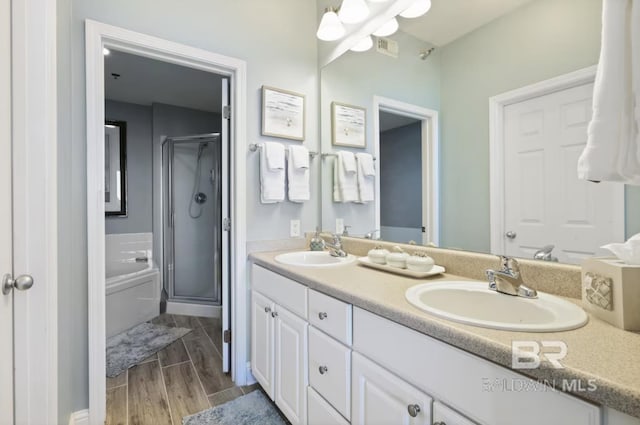 455 E Beach Blvd Unit 807, Gulf Shores, AL 36542 - full bath with a shower stall, double vanity, wood finished floors, and a garden tub