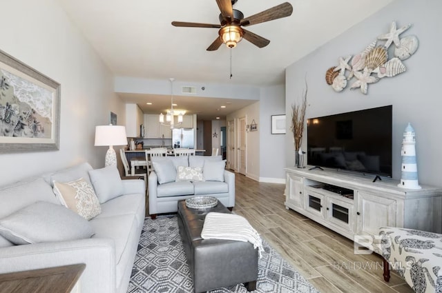 455 E Beach Blvd Unit 807, Gulf Shores, AL 36542 - living area featuring wood finish floors, a chandelier, a ceiling fan, and baseboards