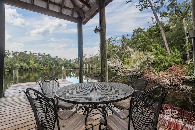 wooden deck featuring a dock and a water view