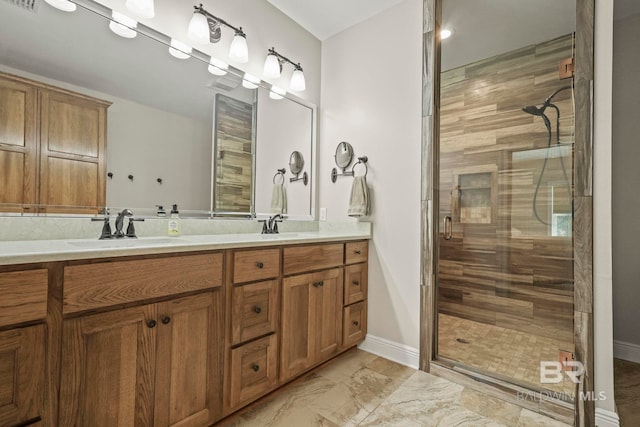 bathroom featuring double vanity, a stall shower, and a sink