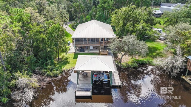 bird's eye view with a water view and a wooded view