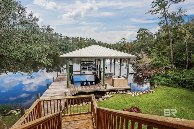 view of dock featuring a yard and boat lift