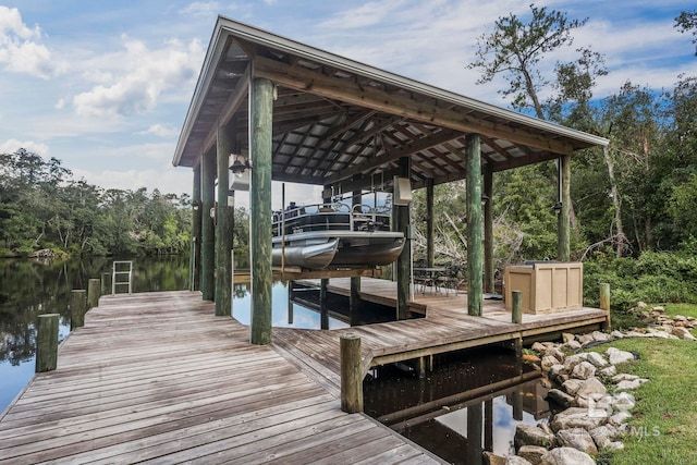 dock area with a water view and boat lift