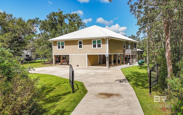 view of front of home featuring a carport, a front yard, and driveway