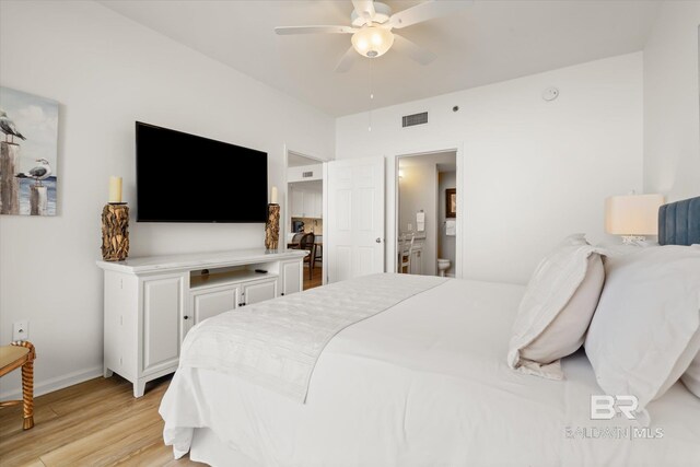 bedroom featuring ceiling fan, ensuite bathroom, and light hardwood / wood-style floors