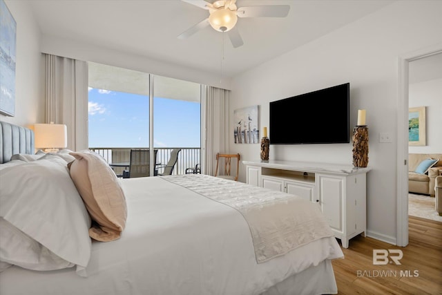 bedroom featuring access to outside, light hardwood / wood-style floors, and ceiling fan