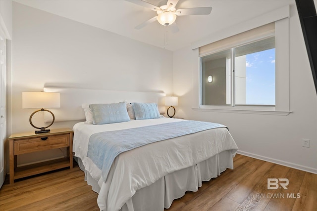 bedroom with wood-type flooring and ceiling fan