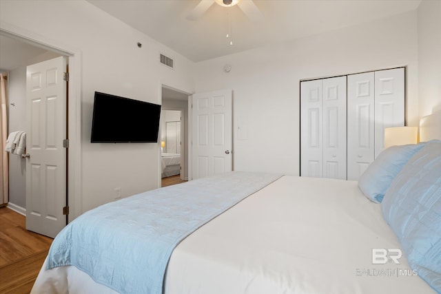 bedroom featuring wood-type flooring, a closet, and ceiling fan