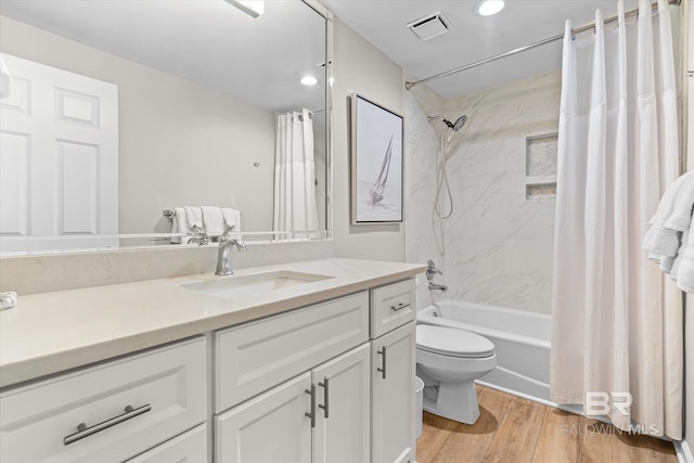 full bathroom with vanity, wood-type flooring, shower / bath combo, and toilet