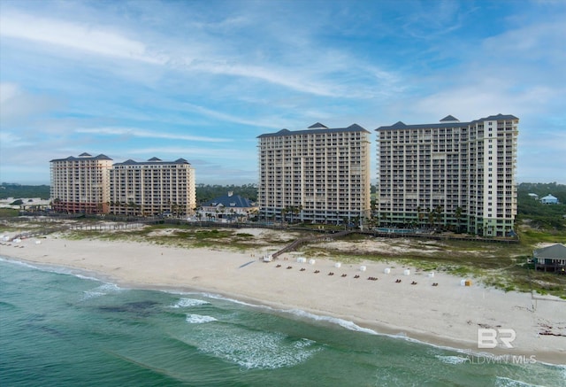 birds eye view of property with a water view and a beach view