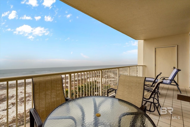 balcony featuring a water view and a beach view