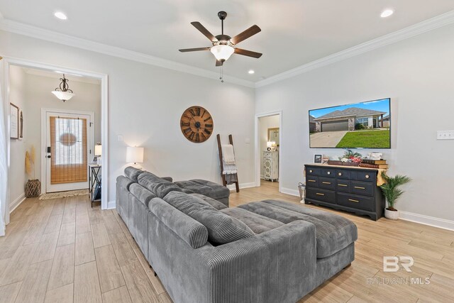 living room with crown molding, light hardwood / wood-style flooring, and ceiling fan