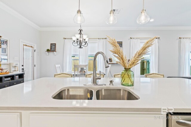 kitchen with pendant lighting, an island with sink, a notable chandelier, and sink