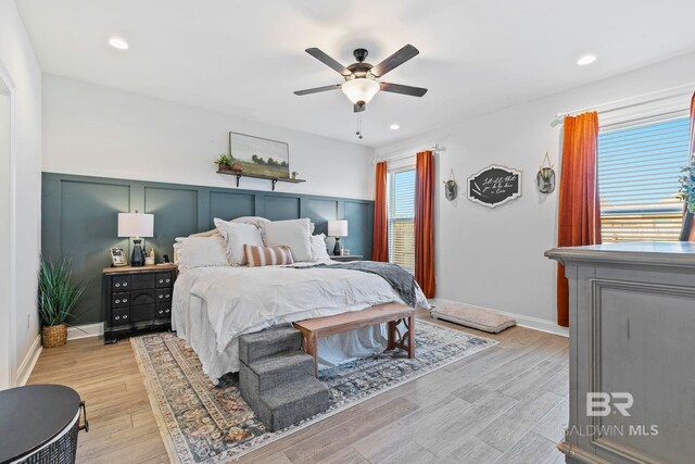 bedroom featuring ceiling fan and light hardwood / wood-style floors