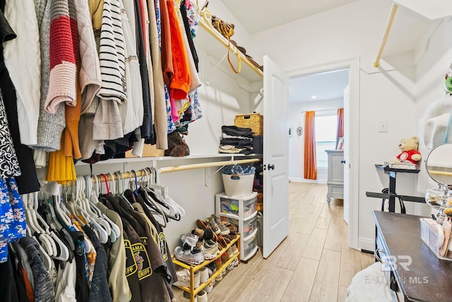 spacious closet featuring light hardwood / wood-style floors