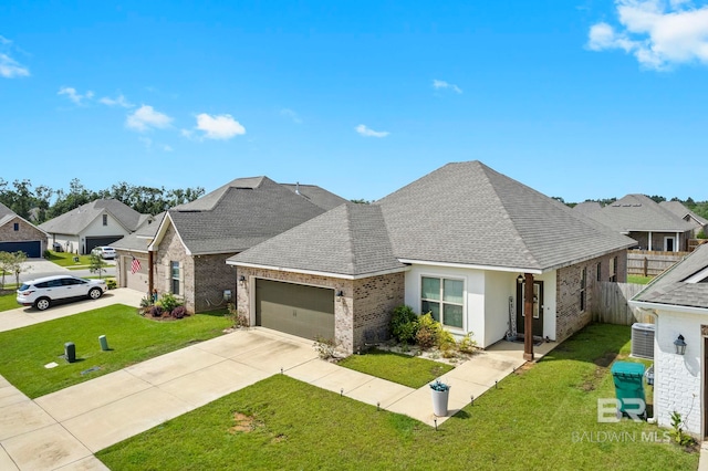 view of front of house with central air condition unit, a garage, and a front yard