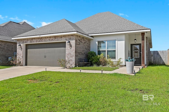 view of front of property featuring a front yard and a garage