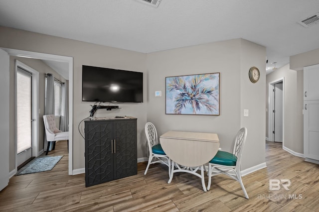 27222 Gulf Rd, Orange Beach, AL 36561 - dining area with light wood-type flooring and baseboards