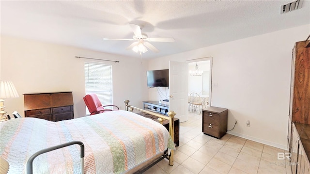 bedroom featuring light tile patterned floors, a textured ceiling, and ceiling fan