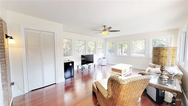 interior space featuring dark wood-type flooring and ceiling fan